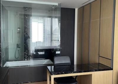 Modern bathroom with glass shower and built-in desk