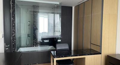 Modern bathroom with glass shower and built-in desk