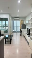 Modern living room with a balcony and plenty of natural light