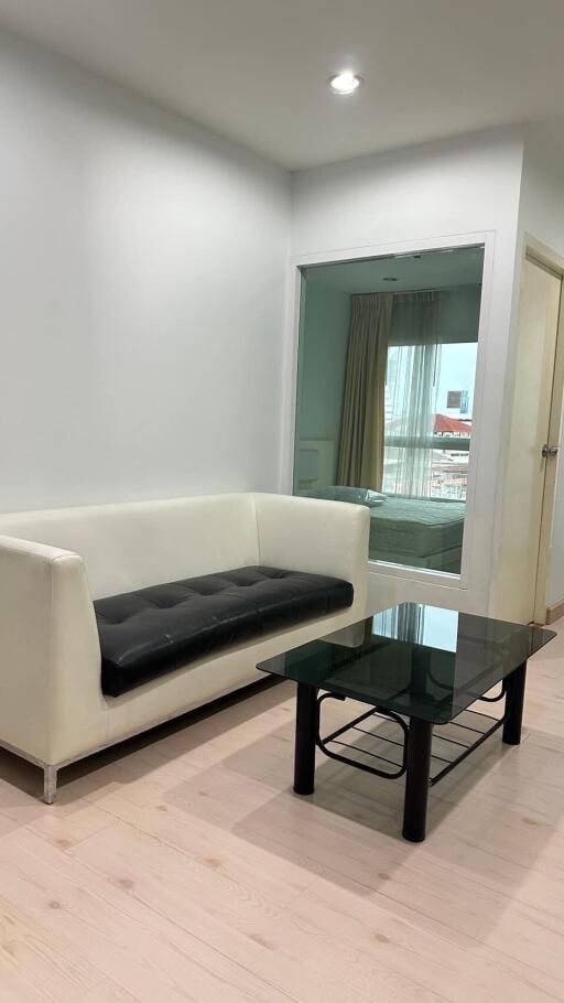 Living room with a white sofa and glass coffee table