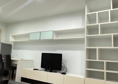 Modern living room with open shelving and TV unit