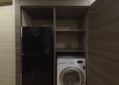 Laundry area with washer and refrigerator