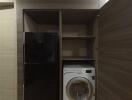 Laundry area with washer and refrigerator