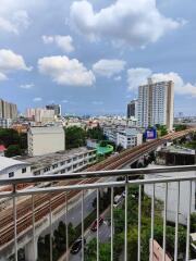 City view from a balcony showcasing railways and buildings