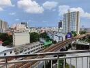 City view from a balcony showcasing railways and buildings