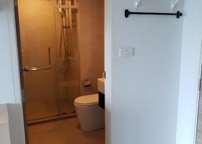 Bathroom with glass-enclosed shower and shelf
