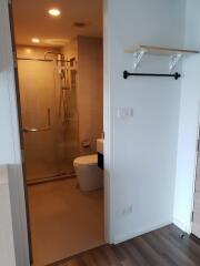 Bathroom with glass-enclosed shower and shelf