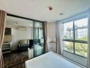 Bedroom with glass sliding doors, view of adjacent living room area, large windows with city view, and wooden floors