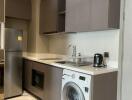 Modern kitchen with grey cabinetry and built-in appliances