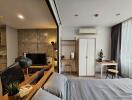 Modern multifunctional bedroom with study nook, wardrobe, and kitchenette