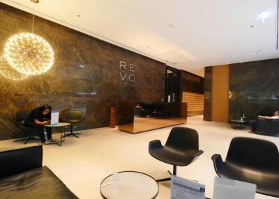 Modern building lobby with seating area and reception desk