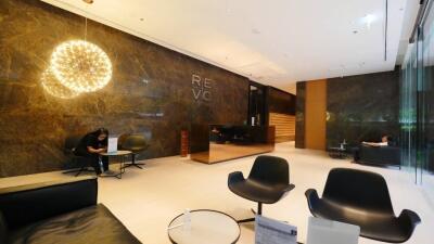 Modern building lobby with seating area and reception desk