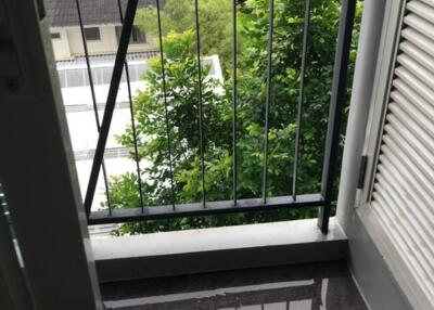 Balcony with railing overlooking trees