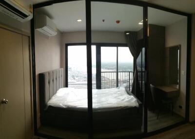 Bedroom with a balcony view and a workspace
