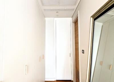 Bright hallway with wooden flooring and full-length mirror