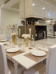 Elegant kitchen and dining area with table set for dinner