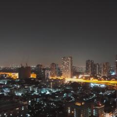 Night view of a cityscape with illuminated buildings and streets