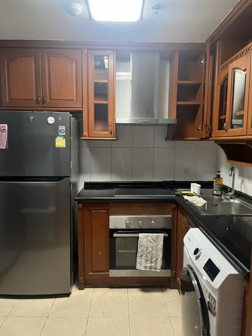 Modern kitchen with stainless steel appliances and wooden cabinets