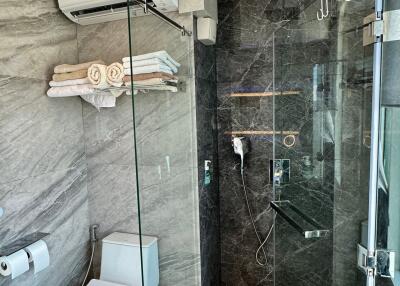 Modern bathroom with glass-enclosed shower and toilet