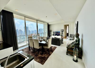 Spacious living and dining area with large windows and city view
