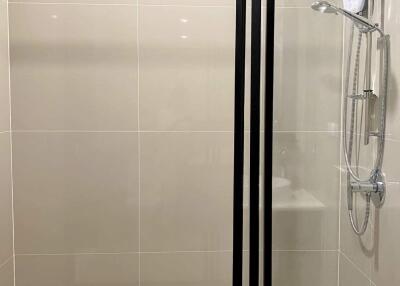 Modern bathroom with glass shower partition and shower head