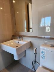 Modern bathroom with sink, mirror, and toilet