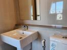 Modern bathroom with sink, mirror, and toilet