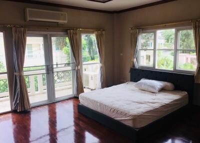 Spacious bedroom with large windows and double bed