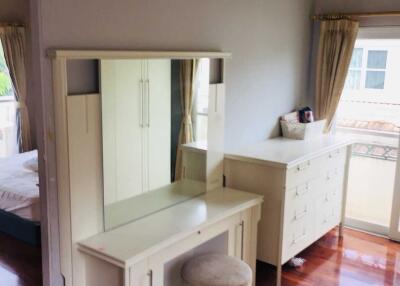 Bright bedroom with a dressing table and chest of drawers