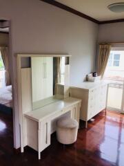 Bright bedroom with a dressing table and chest of drawers