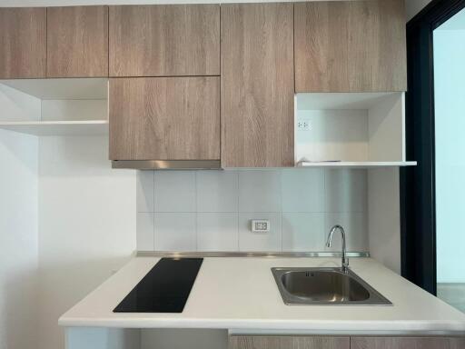 Modern kitchen with wooden cabinetry and white countertop