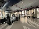 Modern gym with natural lighting and workout equipment