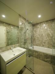 Modern bathroom with glass shower panel and bathtub