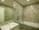 Modern bathroom with glass shower panel and bathtub