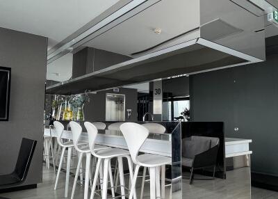 Modern kitchen with high chairs and sleek design