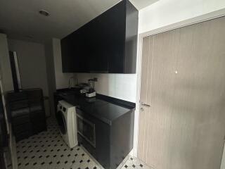 Laundry room with washer, cabinets, and countertop