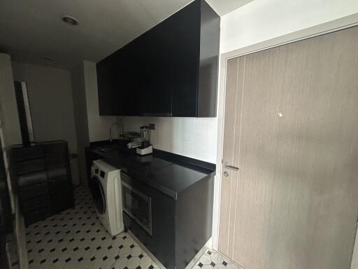 Laundry room with washer, cabinets, and countertop