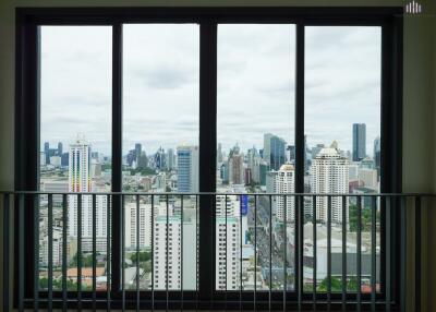 View from the window showing a cityscape with high-rise buildings.