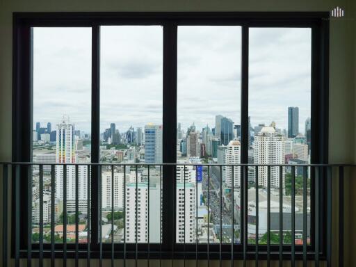 View from the window showing a cityscape with high-rise buildings.