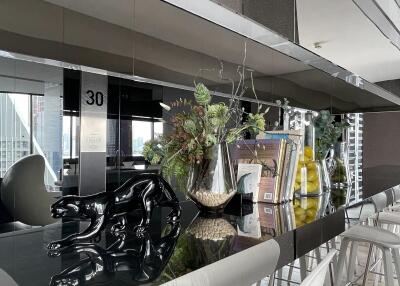 Modern kitchen with reflective mirror backsplash and sleek bar area
