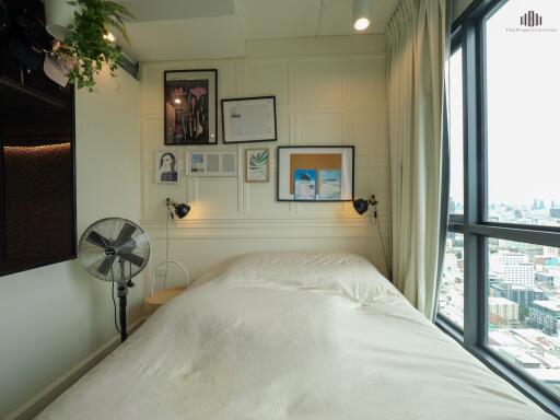 Bedroom with a bed, wall decorations, and a view