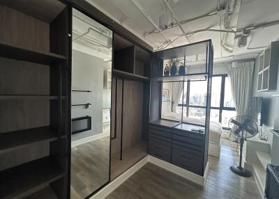 Bedroom with built-in wardrobes, a large mirror, and an external view