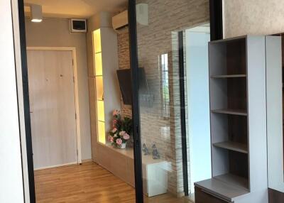 Modern living room with hardwood floors, sliding glass door and built-in shelves