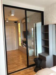 Modern living room with hardwood floors, sliding glass door and built-in shelves