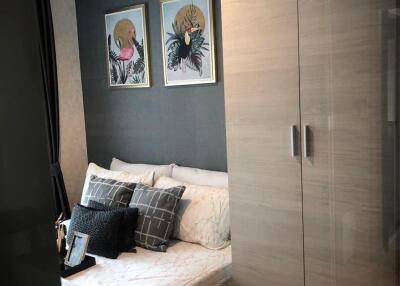 Bedroom with double bed, wardrobe, and framed artwork