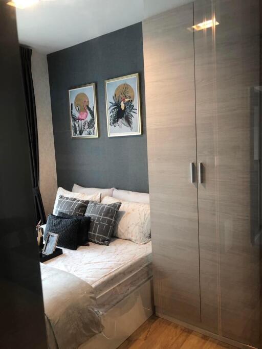 Bedroom with double bed, wardrobe, and framed artwork