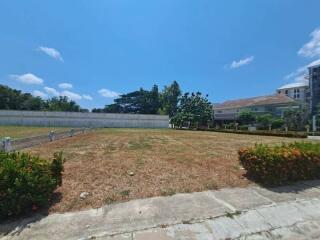 Outdoor area with grassy field and surrounding buildings