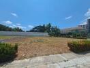 Outdoor area with grassy field and surrounding buildings