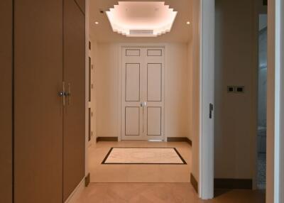 Elegant hallway with recessed ceiling and double doors