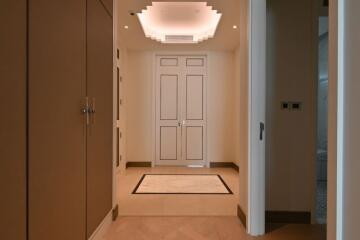 Elegant hallway with recessed ceiling and double doors